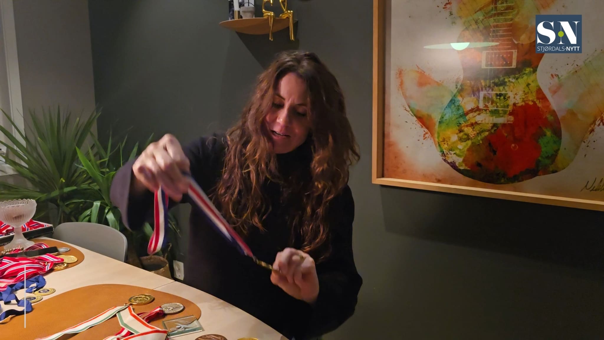Elisabeth Hilmo viser fram medaljene fra mesterskap og OL